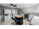Updated kitchen with stainless steel appliances, modern cabinetry and a large island at 13610 W Dakota Pl, Lakewood, CO 80228