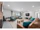 Expansive living room with comfortable seating, fireplace, and access to the outdoor balcony at 13610 W Dakota Pl, Lakewood, CO 80228