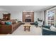 Inviting living room featuring a brick fireplace, plush seating and natural light at 13610 W Dakota Pl, Lakewood, CO 80228
