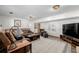 Spacious living room with plush sofa, dark wooden accents, and a soft carpet creates a welcoming and relaxing atmosphere at 13610 W Dakota Pl, Lakewood, CO 80228