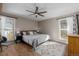 Spacious bedroom with hardwood floors, a ceiling fan, natural light, and a neutral-toned rug at 13610 W Dakota Pl, Lakewood, CO 80228