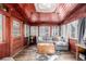 Cozy sunroom with wood paneled walls, skylight, and comfortable seating, perfect for relaxing and enjoying natural light at 13610 W Dakota Pl, Lakewood, CO 80228