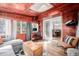 Bright sunroom with natural lighting featuring a comfortable seating area and desk workspace, seamlessly connecting indoors and outdoors at 13610 W Dakota Pl, Lakewood, CO 80228