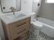 Updated bathroom with subway tile, a new vanity, and a decorative tile floor at 3243 Albion St, Denver, CO 80207