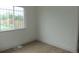 Bedroom with wood-look floors, fresh paint, white baseboards, and a window with decorative bars at 3243 Albion St, Denver, CO 80207
