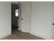Bedroom with neutral paint, wood-look flooring, white baseboards, and dark door hardware at 3243 Albion St, Denver, CO 80207