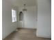Bright dining room features stylish flooring, a modern light fixture, and a built-in display cabinet at 3243 Albion St, Denver, CO 80207