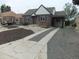 Charming brick home featuring a well maintained yard and driveway leading to a covered parking area at 3243 Albion St, Denver, CO 80207