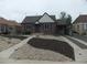 Charming brick home featuring a well maintained yard and driveway leading to a covered parking area at 3243 Albion St, Denver, CO 80207