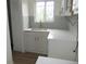Modern kitchen features sleek white countertops, a stylish faucet, and updated cabinets at 3243 Albion St, Denver, CO 80207