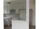 An updated kitchen with white cabinets, gray tile backsplash, and a convenient pass-through at 3243 Albion St, Denver, CO 80207