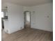 Bright living room with fresh paint, hardwood floors, an arched doorway, and stylish trim at 3243 Albion St, Denver, CO 80207