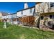 Backyard showcasing green grass, a wooden fence and row of townhomes at 1621 S Idalia Cir # D, Aurora, CO 80017