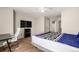 Bright bedroom with a TV, desk, and vinyl wood flooring at 1621 S Idalia Cir # D, Aurora, CO 80017