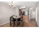 Cozy dining area next to the kitchen, featuring a table with four chairs and a chandelier at 1621 S Idalia Cir # D, Aurora, CO 80017