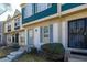 Charming townhome featuring a blue front door, updated windows, and well-maintained landscaping at 1621 S Idalia Cir # D, Aurora, CO 80017