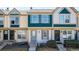 Charming townhome featuring a blue front door, updated windows, and well-maintained landscaping at 1621 S Idalia Cir # D, Aurora, CO 80017