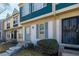 Charming townhome featuring a blue front door, updated windows, and well-maintained landscaping at 1621 S Idalia Cir # D, Aurora, CO 80017