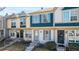 Charming townhome featuring a blue front door, updated windows, and well-maintained landscaping at 1621 S Idalia Cir # D, Aurora, CO 80017