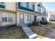 Charming townhome featuring a blue front door, updated windows, and well-maintained landscaping at 1621 S Idalia Cir # D, Aurora, CO 80017