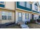 Charming townhome featuring a blue front door, updated windows, and well-maintained landscaping at 1621 S Idalia Cir # D, Aurora, CO 80017