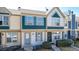 Charming townhome featuring a blue front door, updated windows, and well-maintained landscaping at 1621 S Idalia Cir # D, Aurora, CO 80017