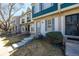Charming townhome featuring a blue front door, updated windows, and well-maintained landscaping at 1621 S Idalia Cir # D, Aurora, CO 80017