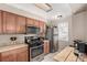 This kitchen has stainless steel appliances, wood cabinets, and ample counter space at 1621 S Idalia Cir # D, Aurora, CO 80017