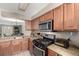 The kitchen opens to living spaces and features stainless steel appliances and wood cabinets at 1621 S Idalia Cir # D, Aurora, CO 80017