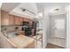 Functional kitchen with wooden cabinets, updated appliances, and access to the back door at 1621 S Idalia Cir # D, Aurora, CO 80017