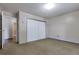 Bedroom featuring a double door closet, neutral walls and carpet, and an entry into a hallway at 13606 E Bates Ave # 102, Aurora, CO 80014