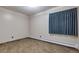 Bedroom area featuring blue window coverings and vinyl flooring at 13606 E Bates Ave # 102, Aurora, CO 80014