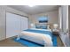 Bedroom featuring large bed, dual nightstands with lamps, and a sliding door closet at 13606 E Bates Ave # 102, Aurora, CO 80014