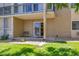 Exterior view of back patio area featuring a green lawn and rock landscaping at 13606 E Bates Ave # 102, Aurora, CO 80014