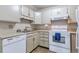 Bright kitchen with white cabinets, and modern appliances including a dishwasher and a range at 13606 E Bates Ave # 102, Aurora, CO 80014