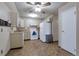 Spacious kitchen with white cabinets, modern appliances, and neutral countertops and flooring at 13606 E Bates Ave # 102, Aurora, CO 80014