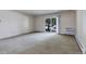 A spacious living room with sliding glass door leading to the outside and a radiant heater at 13606 E Bates Ave # 102, Aurora, CO 80014