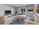 Comfortable living room featuring a plush sofa, armchair, and a coffee table on an area rug at 13606 E Bates Ave # 102, Aurora, CO 80014