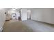 Bright living area leading into an open kitchen featuring white cabinets and appliances at 13606 E Bates Ave # 102, Aurora, CO 80014