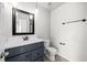 Bathroom with gray vanity, tile floors, and modern fixtures at 1712 S Kline Way, Lakewood, CO 80232