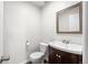 A half bathroom with a modern sink and vanity with a decorative mirror at 1712 S Kline Way, Lakewood, CO 80232