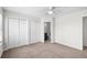 Bedroom featuring a ceiling fan, carpet floors, and double closets at 1712 S Kline Way, Lakewood, CO 80232