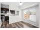 Dining room with wood floors and large window overlooking the backyard at 1712 S Kline Way, Lakewood, CO 80232