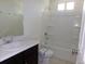 Bright bathroom featuring a shower-tub combo with a built-in shelf and modern vanity at 4551 N Quemoy St, Aurora, CO 80019