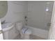 Bright bathroom featuring a shower-tub combo with a built-in shelf and vanity with a pedestal sink at 4551 N Quemoy St, Aurora, CO 80019