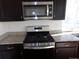 Close up of kitchen details including stainless steel appliances and granite countertops at 4551 N Quemoy St, Aurora, CO 80019
