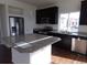 Modern kitchen with stainless steel appliances, a kitchen island, and granite countertops at 4551 N Quemoy St, Aurora, CO 80019