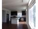 Well-lit kitchen featuring stainless steel appliances, a center island, and dark cabinetry at 4551 N Quemoy St, Aurora, CO 80019