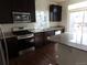 Beautiful kitchen featuring stainless steel appliances, granite countertops, and dark wood cabinets at 4551 N Quemoy St, Aurora, CO 80019