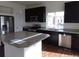 Modern kitchen with stainless steel appliances, a kitchen island, and granite countertops at 4551 N Quemoy St, Aurora, CO 80019